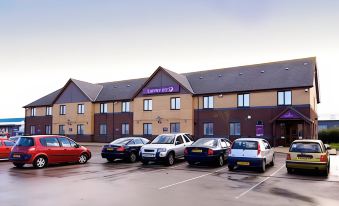 "a row of cars parked in front of a large building with a sign that says "" parkside hotel ""." at Premier Inn Blackpool Airport