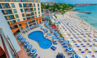 a large resort with a pool surrounded by lounge chairs and umbrellas , providing a relaxing atmosphere at Mirage Hotel