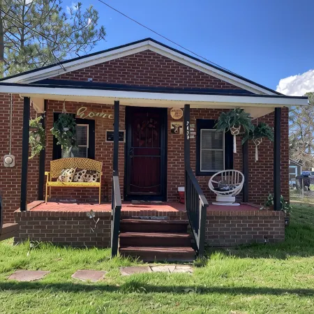 Updated bungalow with screened in porch in rear.