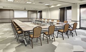 a large conference room with multiple rows of chairs arranged in a semicircle around a long table at Hyatt Place Pittsburgh Airport/Robinson Mall