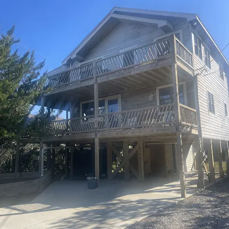 Three-bedroom house with views, decks, golf cart and home gym!