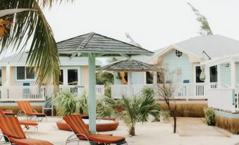 a sandy beach with several lounge chairs and umbrellas set up for relaxation , creating a serene atmosphere at Embrace Resort