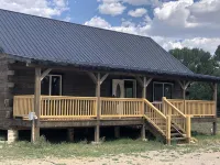 Beautiful hand-crafted log cabin on Horse Creek one block off Main Street.