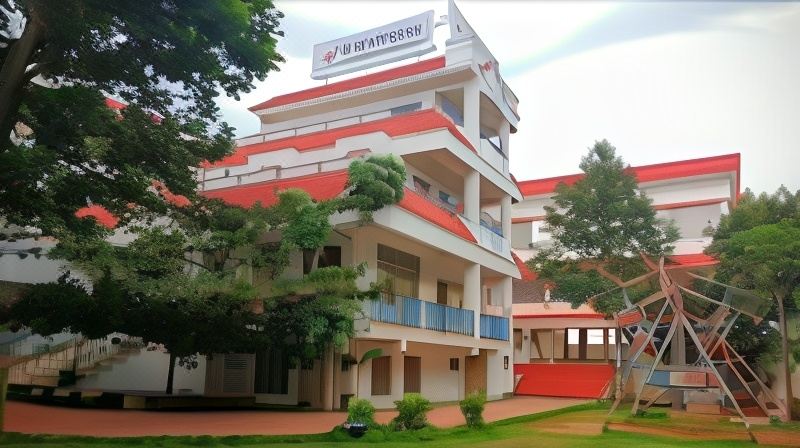 a tall building with a red roof and white walls , surrounded by trees and grass at Rhythm