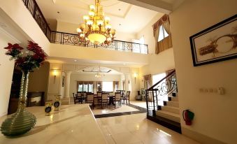 a grand foyer with a large chandelier hanging from the ceiling , creating an elegant atmosphere at Novilla Boutique Resort