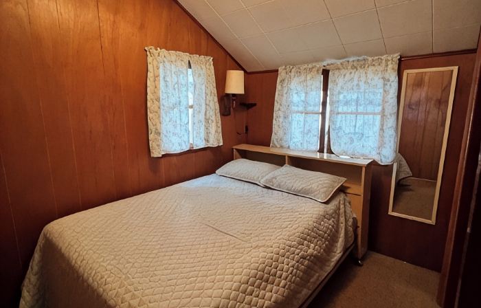 Charming 2-bedroom cabin sits on 2.5 acres on Hubbard Lake.