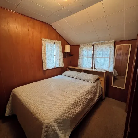 Charming 2-bedroom cabin sits on 2.5 acres on Hubbard Lake.