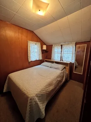 Charming 2-bedroom cabin sits on 2.5 acres on Hubbard Lake.