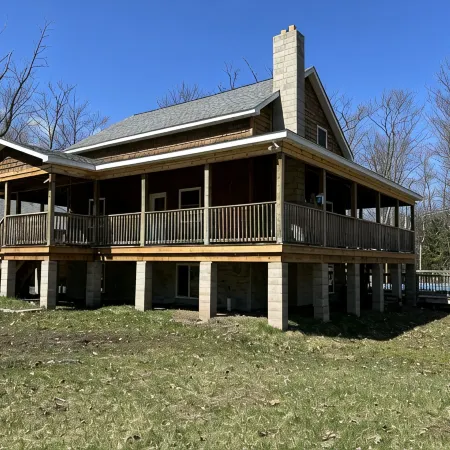 Six bedroom home with a hot tub, pool and an outdoor bar on a two acre lot.