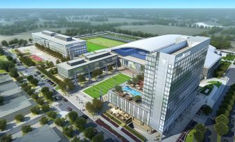 a bird 's eye view of a modern building with a pool and surrounding greenery , possibly representing a hotel or office building at Omni Frisco-Dallas Hotel at the Star