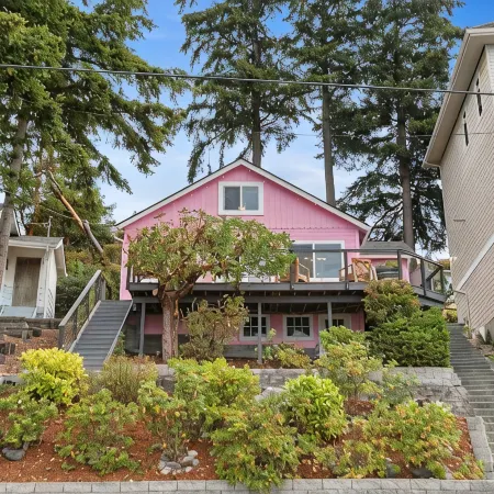 Darling pink beach house with epic views in a cozy community.