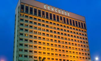 "a tall , modern building with the word "" concordia "" illuminated in white and black letters" at Concorde Hotel Shah Alam