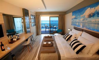 a modern bedroom with a large bed , wooden flooring , and a sliding glass door leading to a balcony at Sunprime C-Lounge
