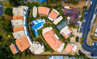 aerial view of a residential area with multiple houses and a pool , surrounded by trees at Lennox Beach Resort