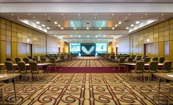 a large conference room with rows of chairs arranged in a semicircle around a long table at London Heathrow Marriott Hotel