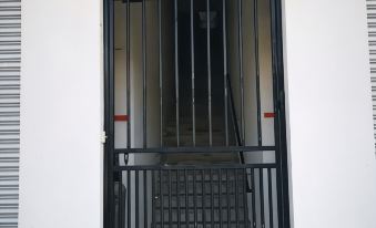 "a black door with a red sign that reads "" comfort inn "" in front of it" at Comfort Inn