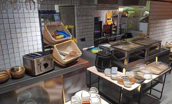 a kitchen with a variety of appliances and utensils , including pots , pans , and cups , as well as bowls and cups at Fabrika