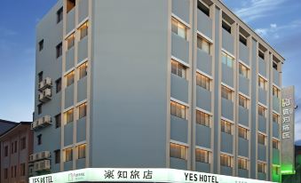 "a tall hotel building with the words "" yes hotel "" prominently displayed on its side , located in a city setting" at Yes Hotel