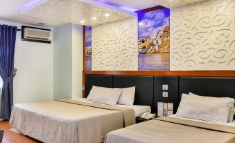 a hotel room with two beds , one on the left and one on the right side of the room at Eurotel Angeles