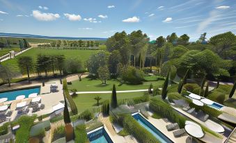 a bird 's eye view of a garden with various trees , a pool , and lounge chairs at Chateau les Carrasses