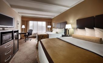 a hotel room with three beds , two of which are twin beds and one is a double bed at Best Western Plus Madison-Huntsville Hotel