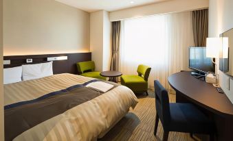 a hotel room with a bed , desk , chair , and tv , along with a window and curtains at Kochi Hotel