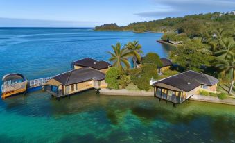 a large body of water with several small houses floating on it , surrounded by trees at Warwick le Lagon Resort & Spa, Vanuatu