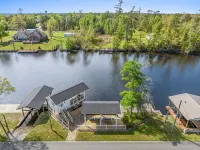 Luxury riverfront home w/ pool, fishing dock, & boat house w/ lift ! Sleeps 14