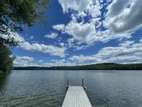 Cozy cabin with deck and fireplace steps from White Pond Lake. Dog friendly.