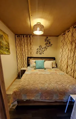 Cozy tiny cabin nested in the trees in a lake community, peaceful countryside.