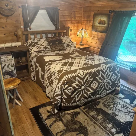 A Stream  runs through it. Comfy little cabin with a stream by your bedroom.