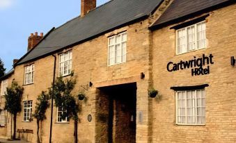 "a brick building with a sign that reads "" cartwright hotel "" prominently displayed on the front of the building" at Cartwright Hotel