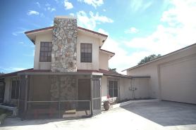 Octagonal 2-story West Palm waterfront home w/dock, boat ramp, & private parking