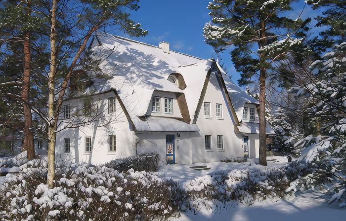 Holiday apartment on the beach in a traditional thatched-roofed house