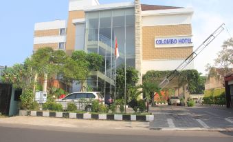 "a large building with a sign that reads "" colombo hotel "" prominently displayed on the front of the building" at Bueno Colombo Hotel Yogyakarta