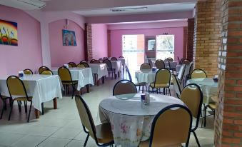 a dining room with tables and chairs arranged for a group of people to enjoy a meal together at Hotel del Sol