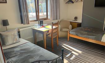 a room with three beds , two of which are twin beds and one is a double bed at The Shakespeare Deluxe Hotel and Caribbean Restaurant Halifax