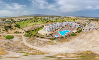 aerial view of a large hotel complex surrounded by sand dunes and a golf course at Ohtels Cabogata