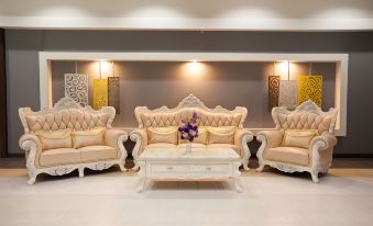 a living room with a large white couch and matching loveseat , along with a coffee table at MaiHom Villa