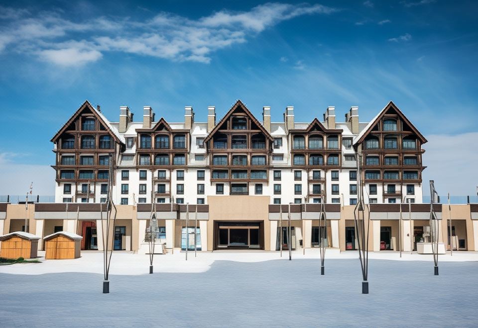 a large building with multiple levels and balconies is shown in front of a clear blue sky at Park Chalet, Shahdag, Autograph Collection