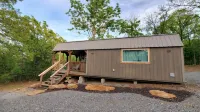 Cozy tiny cabin nested in the trees in a lake community, peaceful countryside.