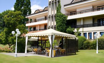 a patio area with a table , chairs , and an awning is shown in front of a building at Hotel Bellavista