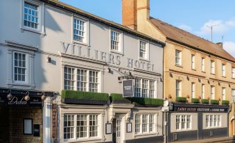 "a white building with the name "" villiers hotel "" on it , located in a city street" at Villiers Hotel