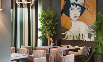 a modern dining area with chairs and tables , a large painting of a woman , and potted plants at Theasis Hotel Paramythia