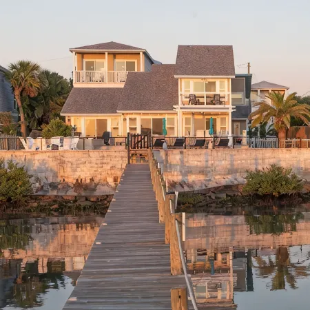 Waterfront home with dock, heated pool, & spectacular views- walk/bike downtown!