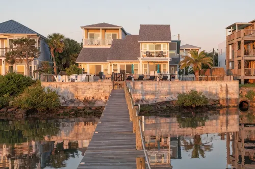 Waterfront home with dock, heated pool, & spectacular views- walk/bike downtown!