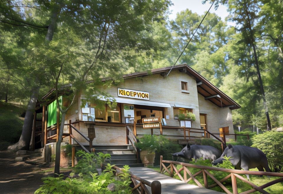 a small restaurant situated in the middle of a forest , surrounded by trees and greenery at Hu Montescudaio Village