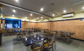 a large dining room with wooden walls , multiple tables , and chairs arranged for a group of people at Hotel MGM Grand