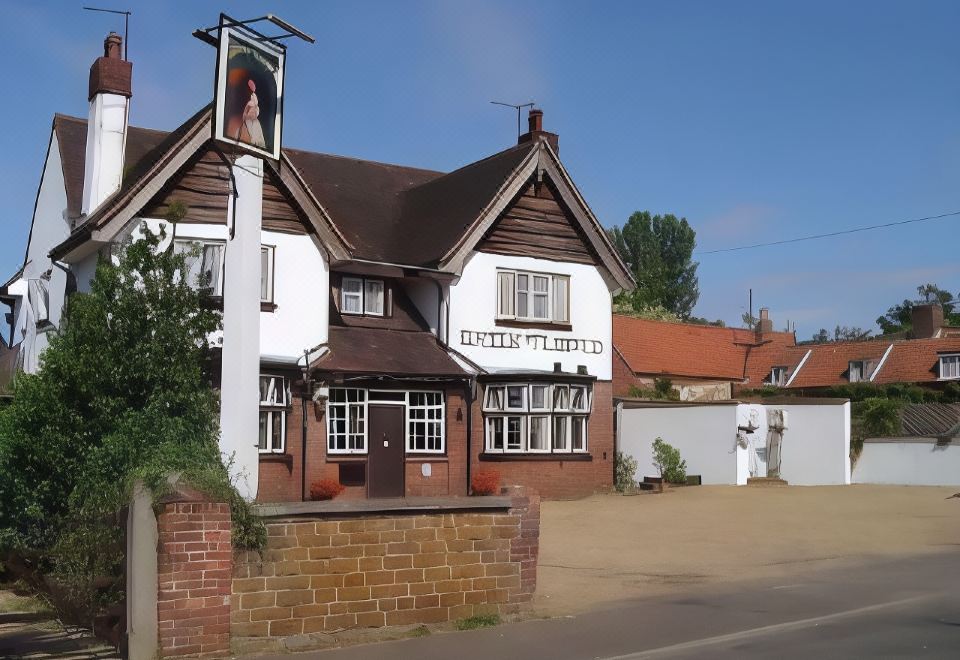 "a brick building with a sign that reads "" english pub "" on it , located in a residential area" at The Queen Victoria