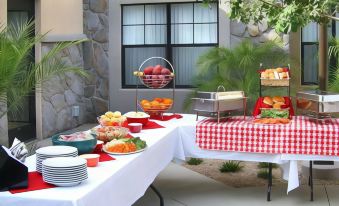 a table is set with a variety of fruits and vegetables for a picnic or gathering at Residence Inn Phoenix Goodyear